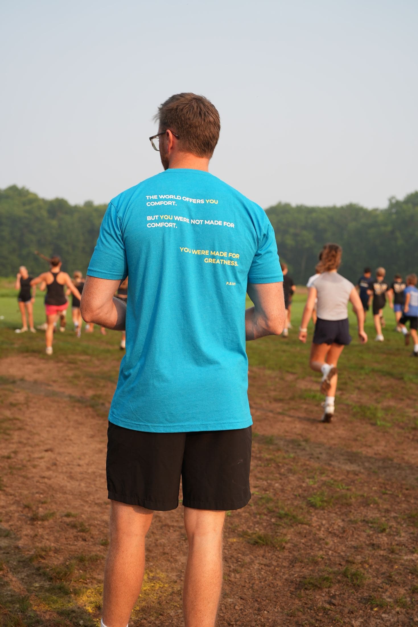 The blue tee from behind at a session — the full manifesto printed across the shoulders