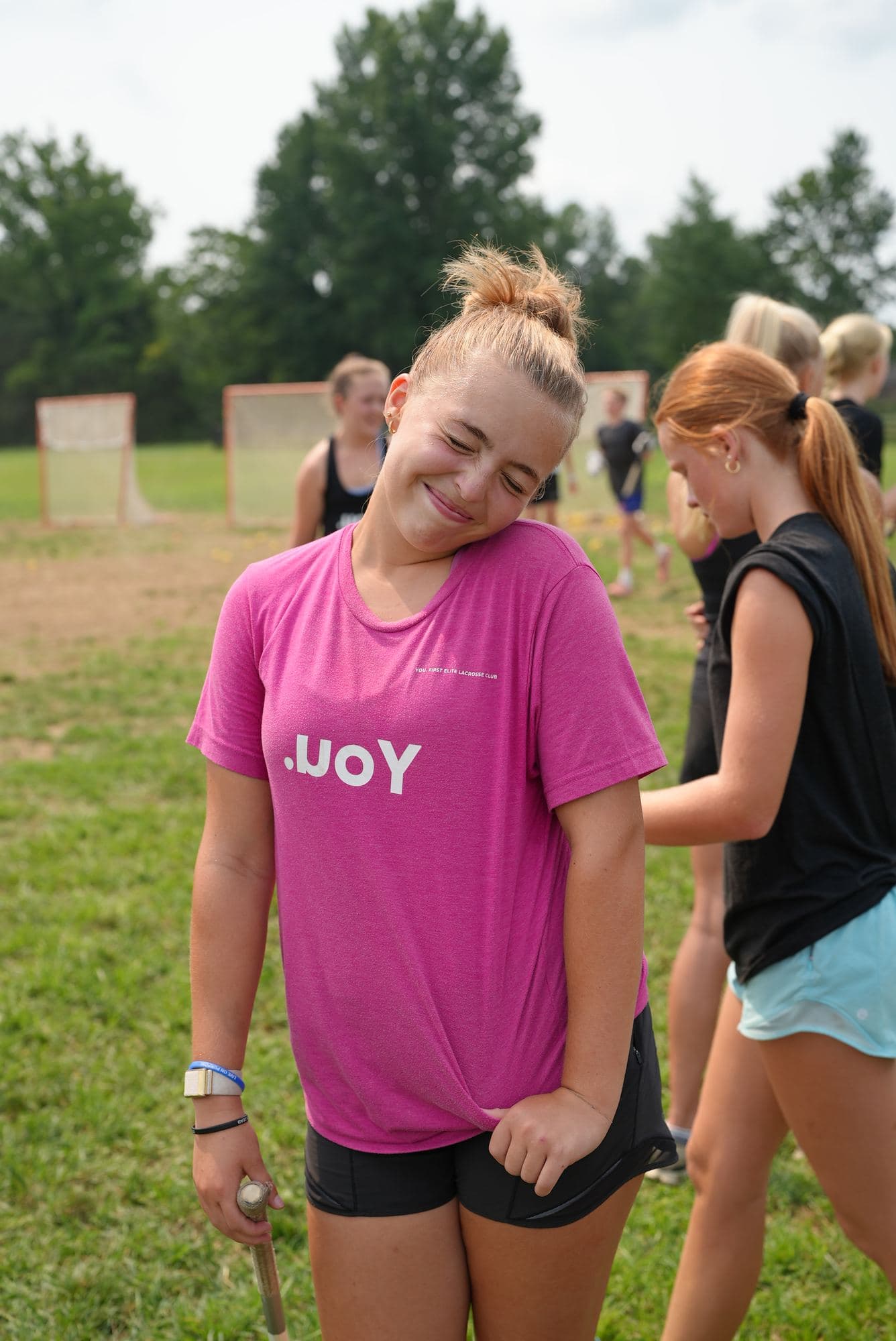 An athlete in the pink tee between reps, the .uoY mark across the chest