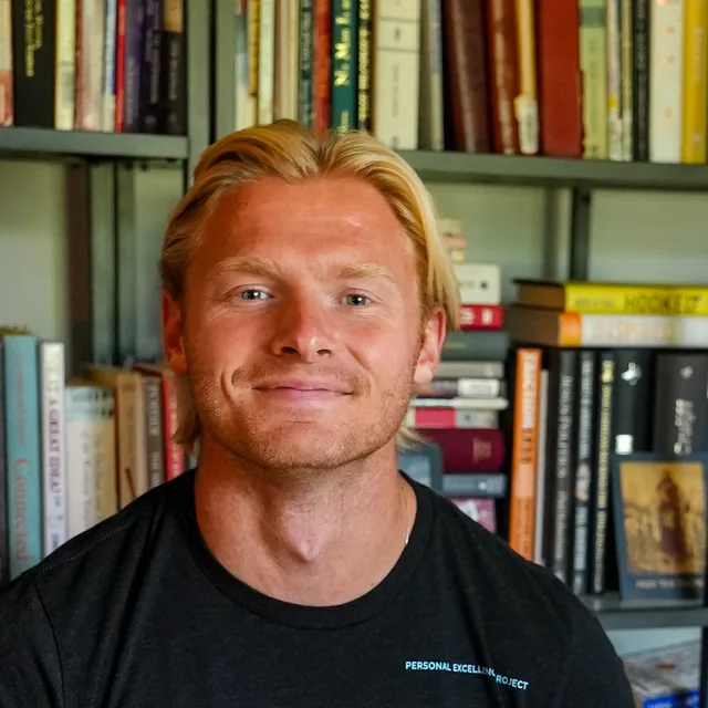 Harrison Schertzinger in front of his bookshelves